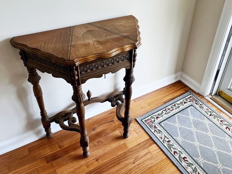 Outdated table in a foyer with fresh walls and flooring
