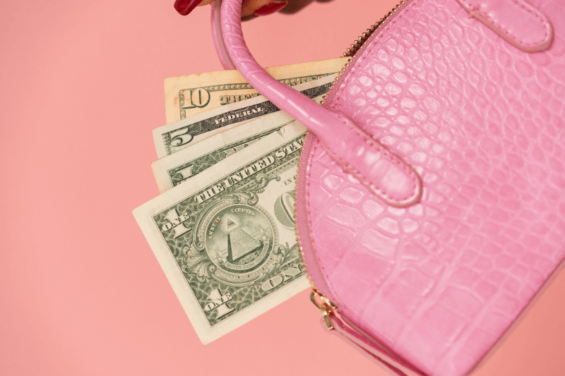 Money coming out of a purse to give to a waitress now instead of later