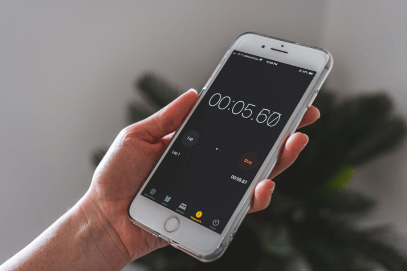Person holding a phone, reflecting on a countdown clock