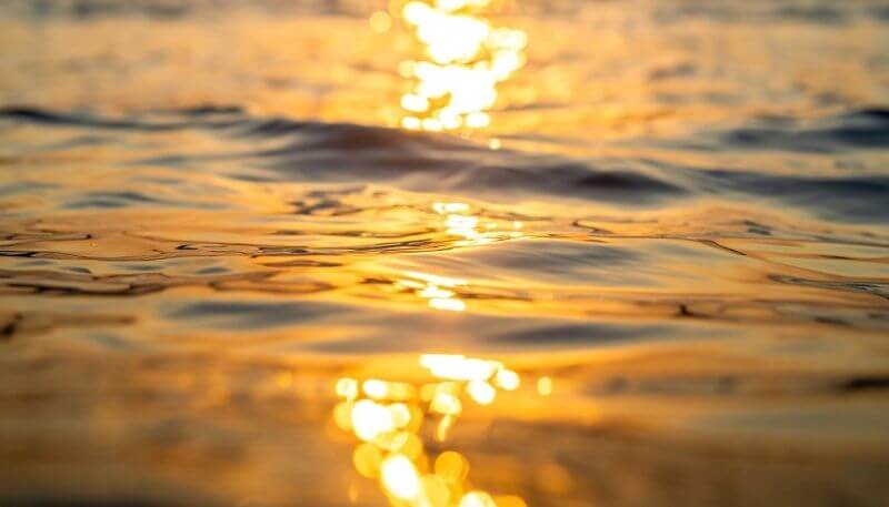 A ripple expanding across calm water, symbolizing small moments creating big impact