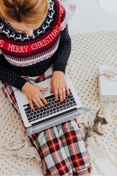 Woman browsing online for gifts, looking frustrated by shipping fees