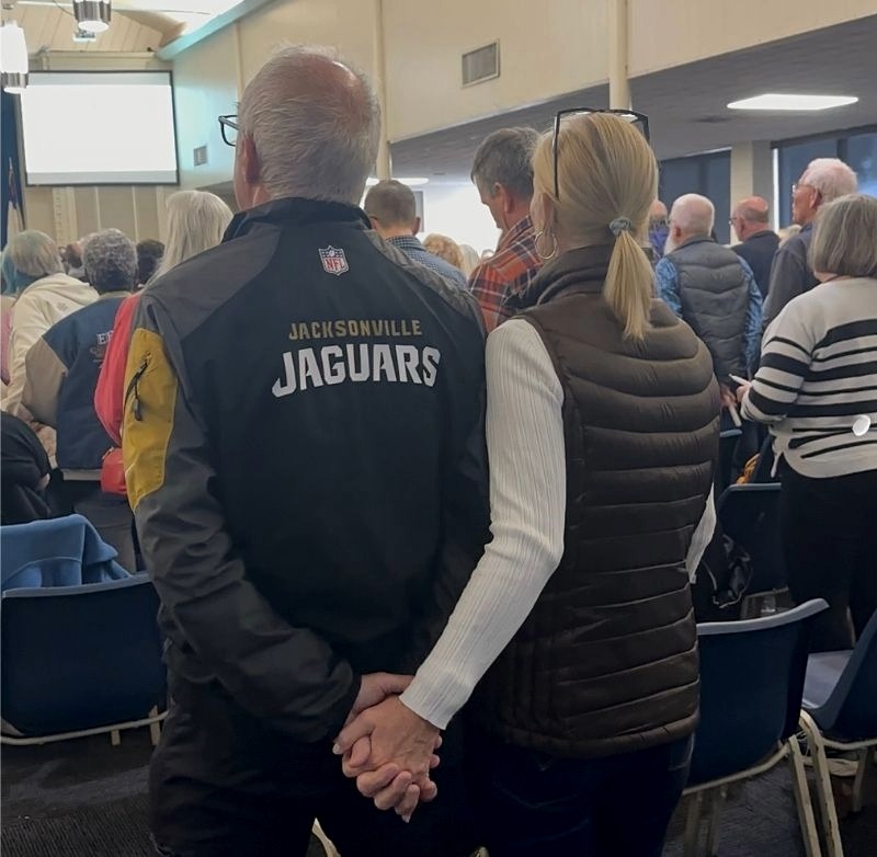 People gathered together at an in-person event, sharing connection