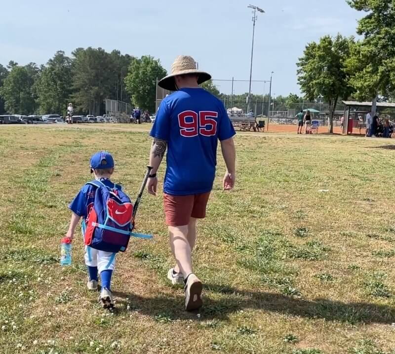 father and son preparing for a tee-ball game