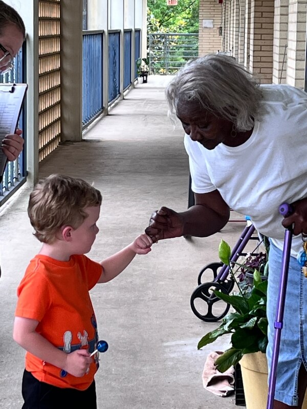 A young boy and an older friend linking pinkies in a promise, illustrating trust, friendship, and connection across generations.